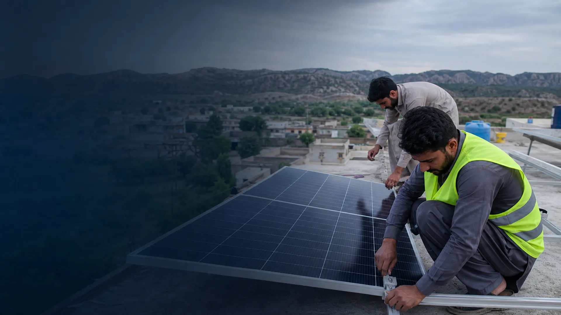 Solar technicians fitting panels on a rooftop in northern Punjab