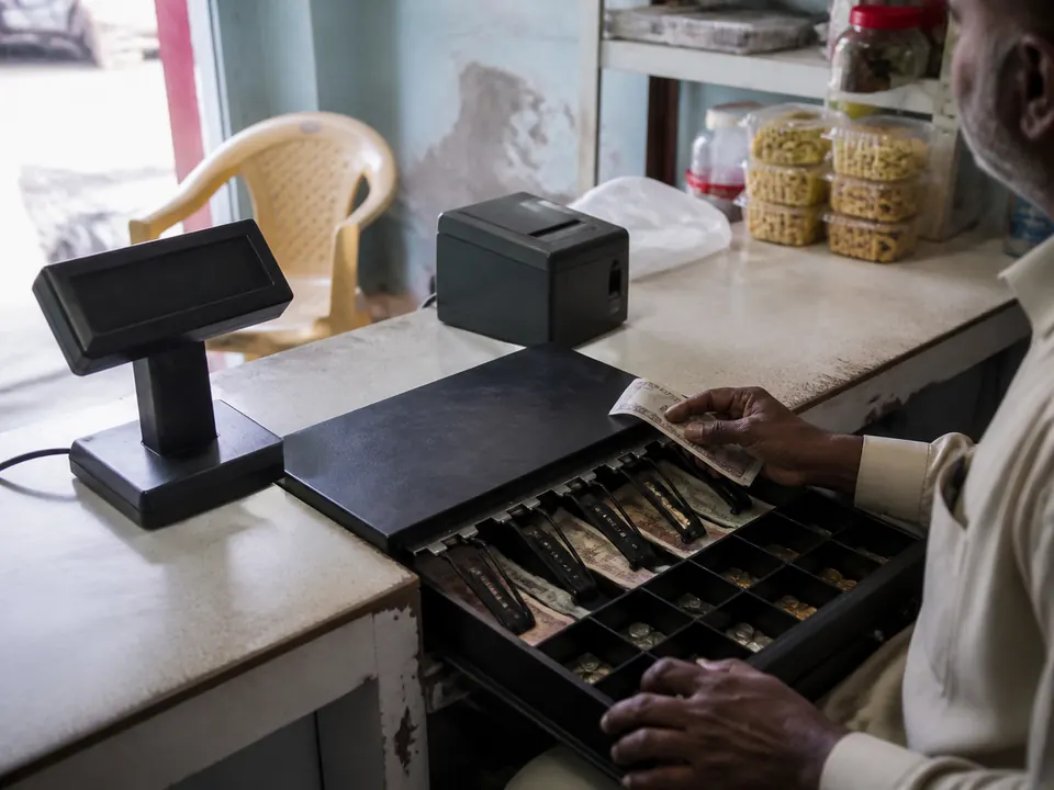 Open cash drawer and customer-facing display after a shop sale