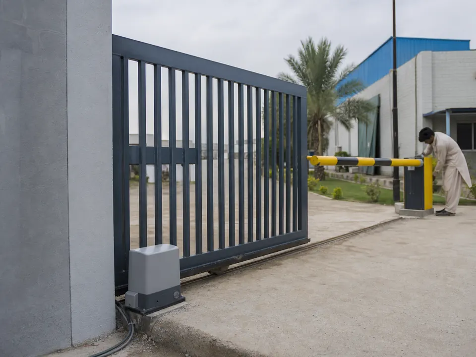 Automatic sliding gate and vehicle barrier at a factory entrance