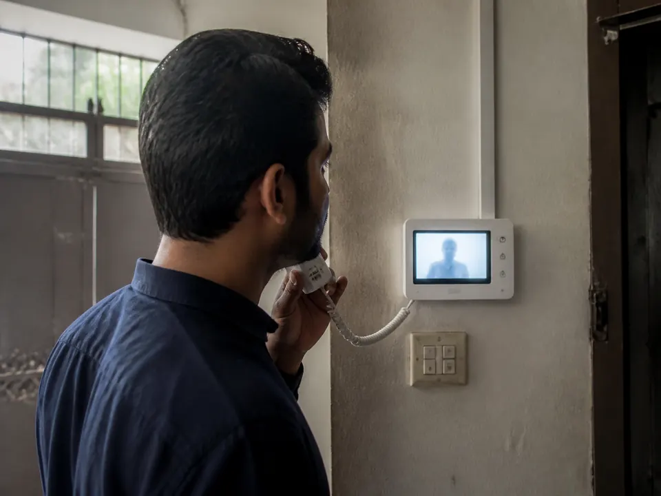 Resident speaking through an indoor video door-phone screen